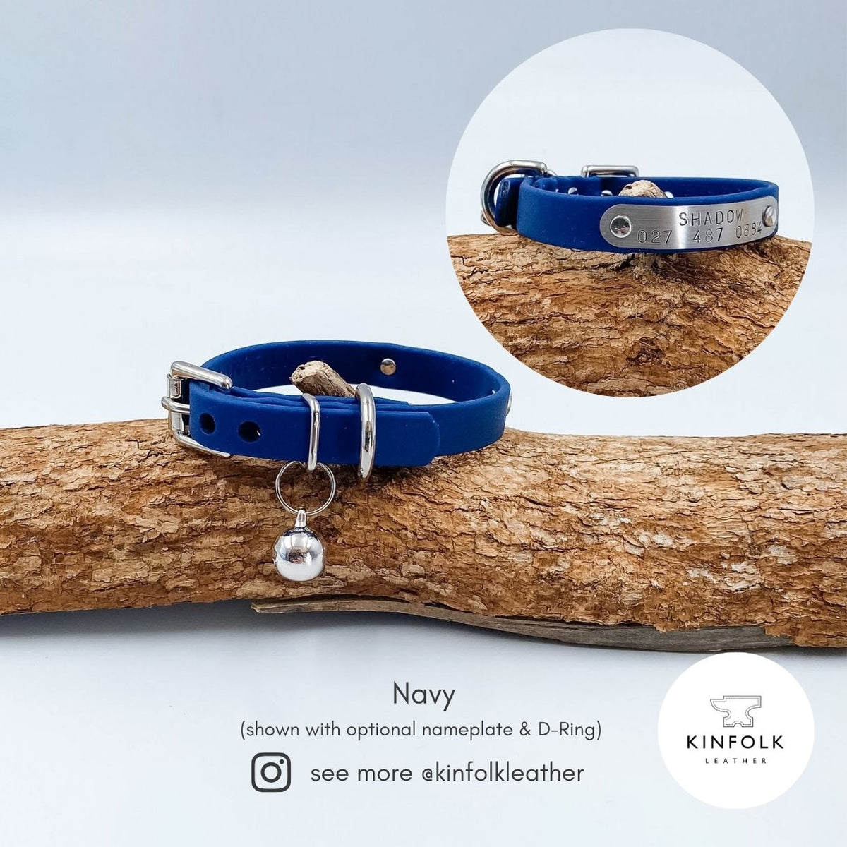 Navy blue BioThane cat collar with silver nickel-plated brass hardware, buckle and removable bell, with close-up detail.