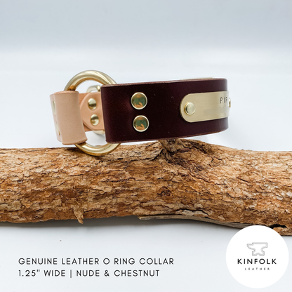 Brown leather dog collar with gold hardware on a wooden branch, featuring the Kinfolk Leather logo.